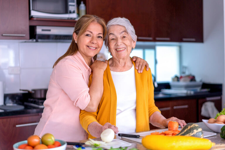 Senior woman in the kitchen with her adult daughter