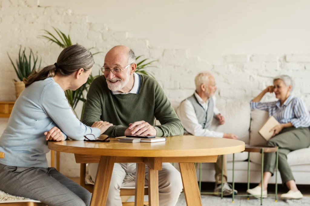 Senior man talking with younger woman