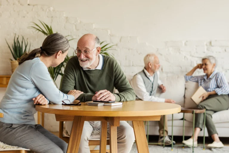 Senior man talking with younger woman