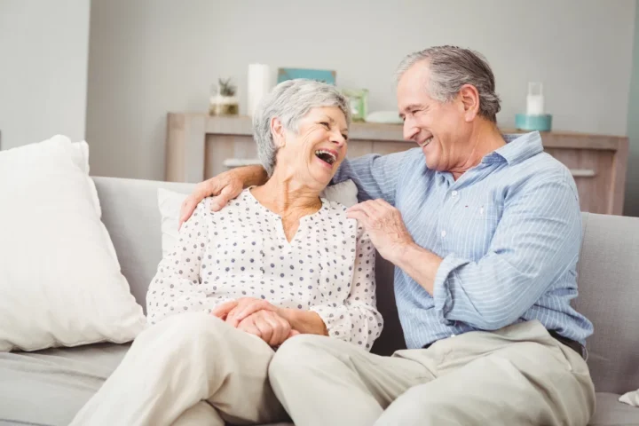 Senior couple laughing in apartment Senior couple laughing in apartment