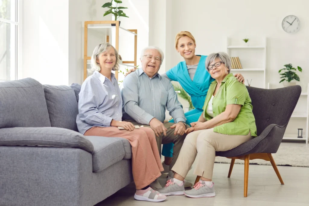 Group of seniors sitting with team member and smiling